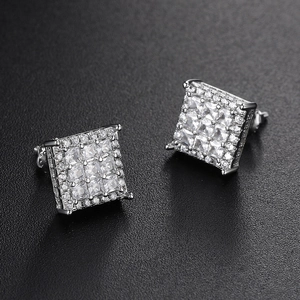 Iced out square stud earrings with pave crystals on black textured background
