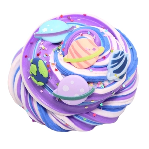 Macro detail of swirled galaxy slime with star sequins and cute planet charms