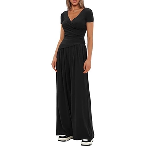 Detail of high-waist black wide-leg pants and V-neck short-sleeve top athletic set