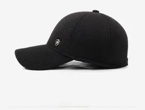 Detail view of winter baseball cap with plush lining and silver shield fashion logo
