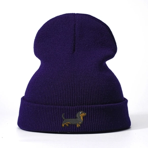 Deep purple knitted beanie with dachshund embroidery on a classic ribbed texture