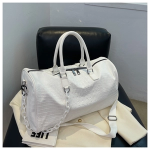 Detailed view of a large capacity white crocodile pattern travel bag with stylish chain