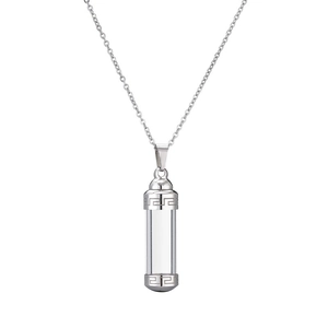 Detailed shot of a silver perfume bottle pendant with Greek key pattern on stainless steel