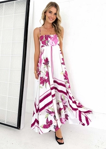 Detail view of sleeveless maxi dress with vibrant floral prints and geometric hem patterns