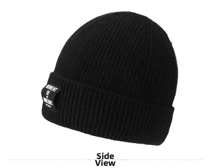 Detail of black ribbed knit beanie featuring thick texture and embroidered logo patch