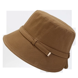 Detail of brown fisherman hat featuring thick cotton texture and a small gold metal buckle