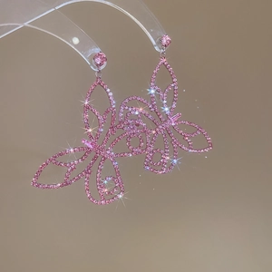 Detailed macro view of pink butterfly earrings with sparkling cubic zirconia on long dangles