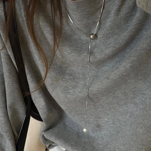 Silver Y-shaped layered sweater necklace with adjustable slider ball detail