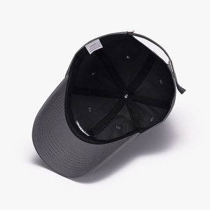 Inside view of dark grey cotton baseball cap with JHC brand label and adjustable strap
