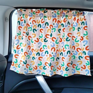 Detailed view of car sunshade curtain with colorful U-shaped patterns on side window
