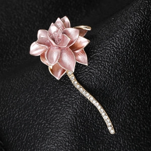 Macro shot of pink enamel lotus petal details and sparkling zircon inlaid on golden stem