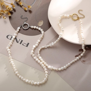 Baroque freshwater pearl necklaces with gold and silver OT buckles on a vintage tray