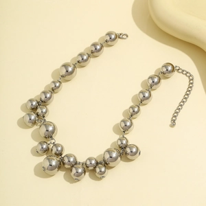 Macro shot of silver metal choker with oversized beads and lobster clasp detail