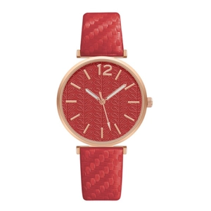 Detailed macro view of the rose gold case and red embossed leaf pattern watch dial