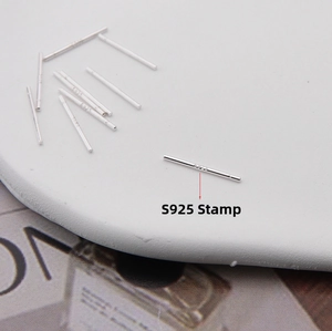 Detailed view of S925 sterling silver ear studs with clear hallmark engraving