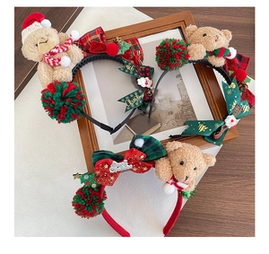 Detailed view of Christmas plush bear headbands with red scarves and sequined star accents