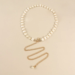 Detail of shell beads waist chain with gold metal links and a pearl pendant charm