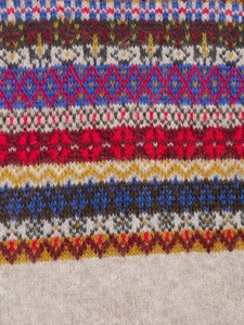 Macro view of multicolored Fair Isle jacquard knit texture on a stylish sweater vest