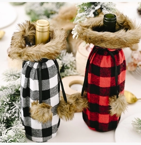 Detail of red and black plaid wine bottle covers with fur collars for Christmas decor