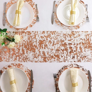 Top view of rose gold round placemats and table runner set with metallic texture