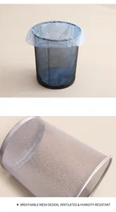 Close-up of breathable mesh design on black and silver round metal waste bins
