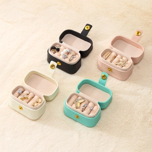 Mini travel jewelry box in PU leather showing ring slots and earring compartments