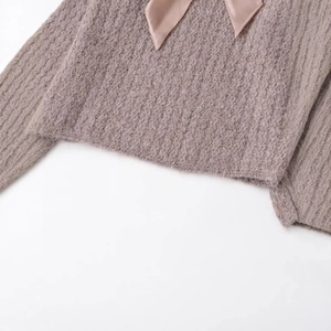Pink knit sweater for women featuring a fuzzy mohair texture and ribbon bow decoration