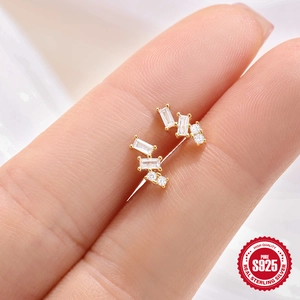 Gold S925 sterling silver square stud earrings with white zircon held between fingers