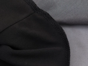 Close-up of contrast stitching between black solid fabric and grey mesh material