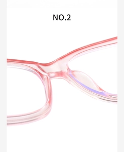 Detail view of pink translucent eyeglass frames showing bridge craftsmanship and nose pads