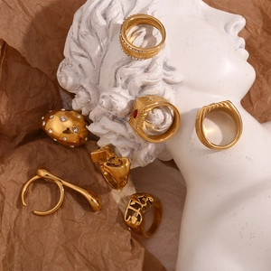 Artistic collection of 18K gold-plated hammered rings with gems on a vintage background