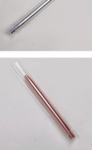 Detail of silver and rose gold bullet-shaped eyelash brushes in protective packaging