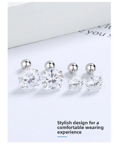 Detailed view of silver screw-back stud earrings with round cubic zirconia in four-prong setting