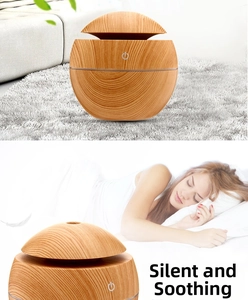 Detail showing wood grain aroma diffuser with touch control icon for quiet operation