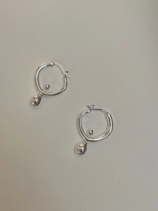 Macro detail of S925 sterling silver stamp on minimalist silver drop hoop earrings