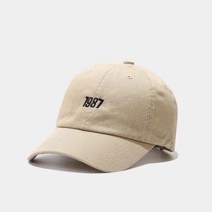 Detail of 1987 black embroidery on beige cotton twill baseball cap with curved brim