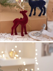 Close-up of a flocked Christmas reindeer with glittered antlers and festive decor