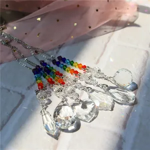 Macro shot of 5 crystal suncatchers with rainbow beads and multifaceted glass prisms