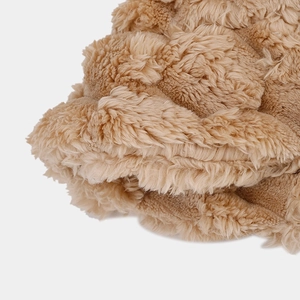 Detailed macro view of the thick tan faux rabbit fur texture and pineapple pattern weave