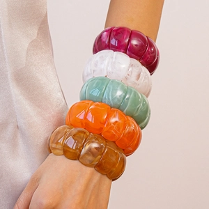 Macro shot of colorful multilayer acrylic stretch bracelets in translucent resin finishes