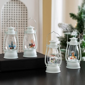 Lighted Christmas lanterns with Santa and reindeer motifs for festive tabletop decoration