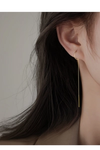 Minimalist long gold chain tassel earrings shown worn on model for elegant drape effect