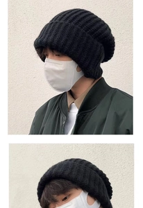 Detailed views of a black chunky knit beanie showcasing thick texture and warm winter fit