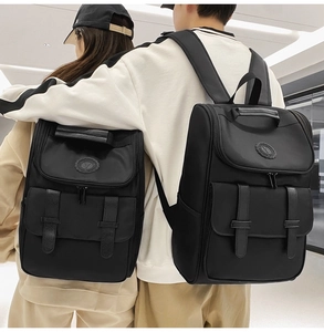 Couples wearing black vintage oxford backpacks showing back view and fit in a mall