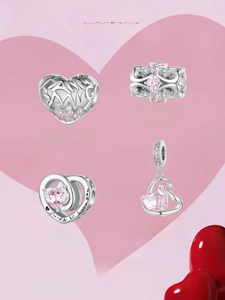Close-up of S925 sterling silver heart charms with pink stones and Lucky to have you text