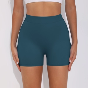 Detail view of deep teal high-waisted yoga shorts with elastic compression fabric