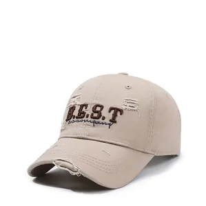 Detail of distressed tan baseball cap featuring 3D embroidery and vintage ripped accents