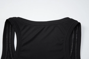Detailed close-up of black ribbed knit fabric neckline and stitching on a slim-fit top