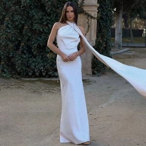 Detail of elegant white satin one-shoulder dress with a floor-length flowing hemline