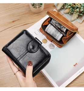Close-up of black and brown oil wax leather wallets with zipper and card slots
